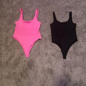 Black and pink body suits